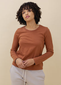 woman wearing basic long sleeve jersey top in rust