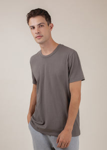 man wearing basic tee in cement