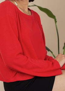 woman wearing boatneck knit sweater in red
