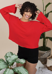 woman wearing boatneck knit sweater in red