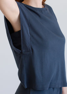 Navy blue top worn by a person on a light gray background