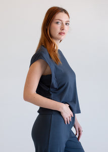 Woman wearing a blue outfit against a plain background