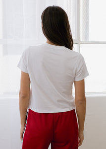 back of woman wearing crop tee in white