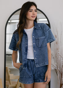 woman wearing cropped indigo short sleeve button down in mineral wash