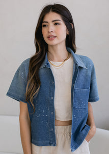 woman wearing cropped indigo short sleeve button down in vintage wash