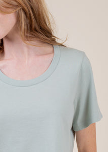 close up woman wearing cropped tee with open neck in sage