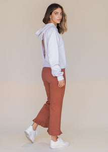 woman wearing cropped frill sweatpants in rust