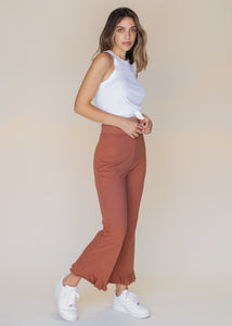 woman wearing cropped frill sweatpants in rust