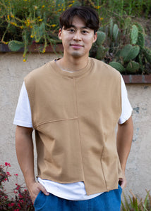 man wearing camel colored vest