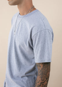 side view of man wearing oversized deadstock tee in heather grey