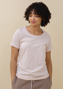 woman wearing relaxed crewneck tee in light pink