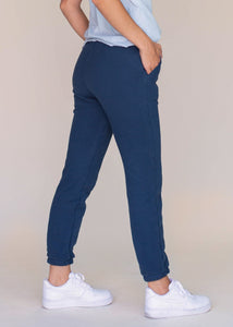back view of woman wearing navy sweatpants