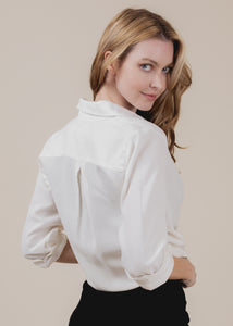 woman wearing button down shirt in cream