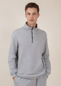 man wearing half zip sweatshirt in heather grey