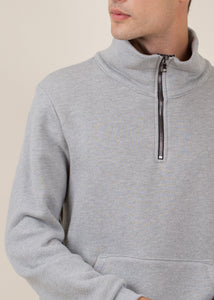 close up of man wearing half zip sweatshirt in heather grey