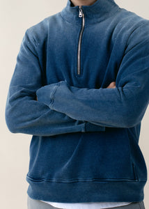 close up of man wearing indigo half zip in vintage wash