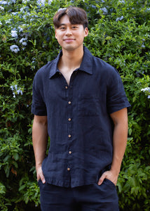 man wearing navy linen button down