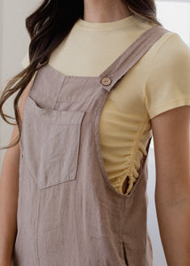 close up of woman wearing linen overall in mushroom