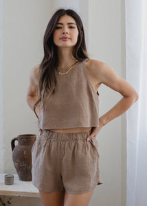woman wearing linen shorts in taupe brown