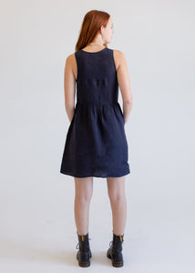 Woman wearing a navy blue dress on a white background