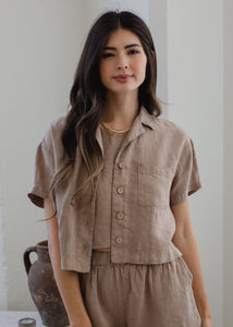 woman wearing linen short sleeve shirt in taupe