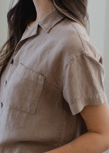 side view of woman wearing linen short sleeve shirt in taupe