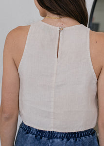 back of woman wearing cropped linen tank in cream