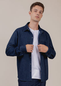 man wearing long sleeve indigo button down with LA patch