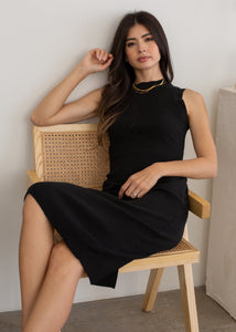 woman sitting down in chair wearing sleeveless rib dress in black