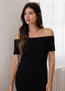 close up of woman wearing off shoulder rib dress in black