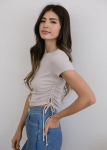 woman wearing ruched crop rib tee in oatmeal glee and co