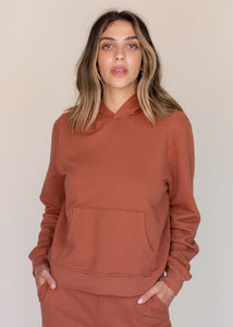 woman wearing basic hoodie in rust